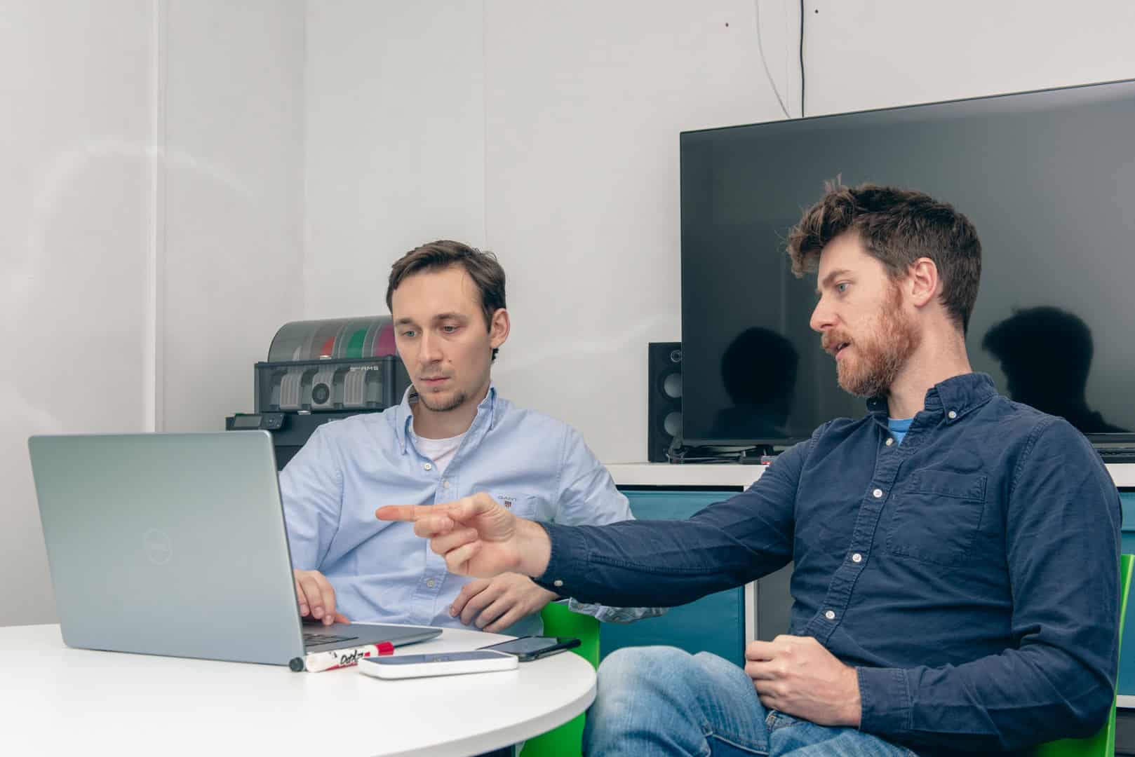 Web design and development team working on a laptop